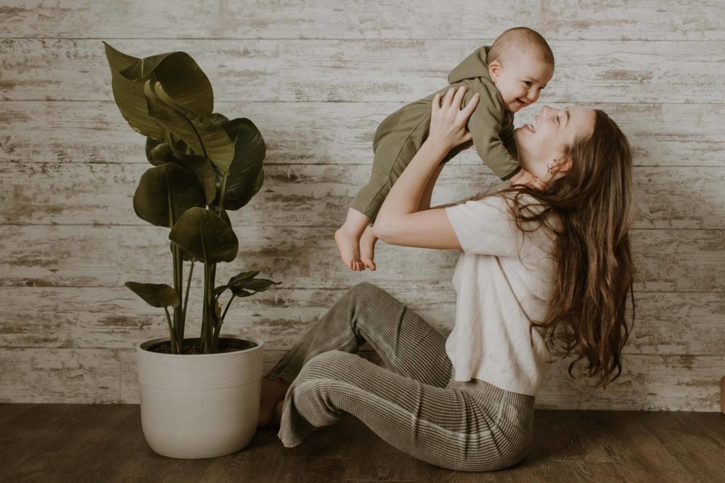 Mother holding child with Birds of Paradise